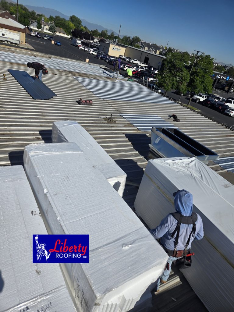 Installing a premium white Versico 60 mil TPO membrane on a flat commercial roof in Provo.