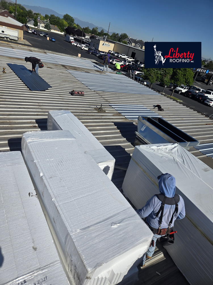 Wide-angle view showing completion of the structural repairs as installation of the Versico 60 mil TPO roofing system begins.