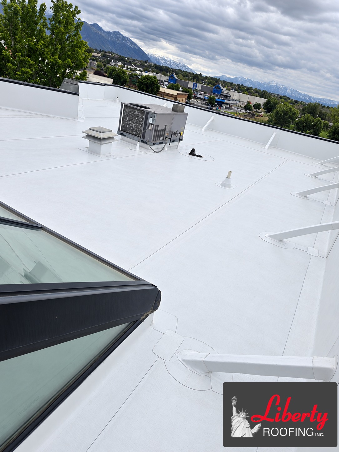 Completed white TPO roof at an insurance company building in Pleasant Grove, Utah