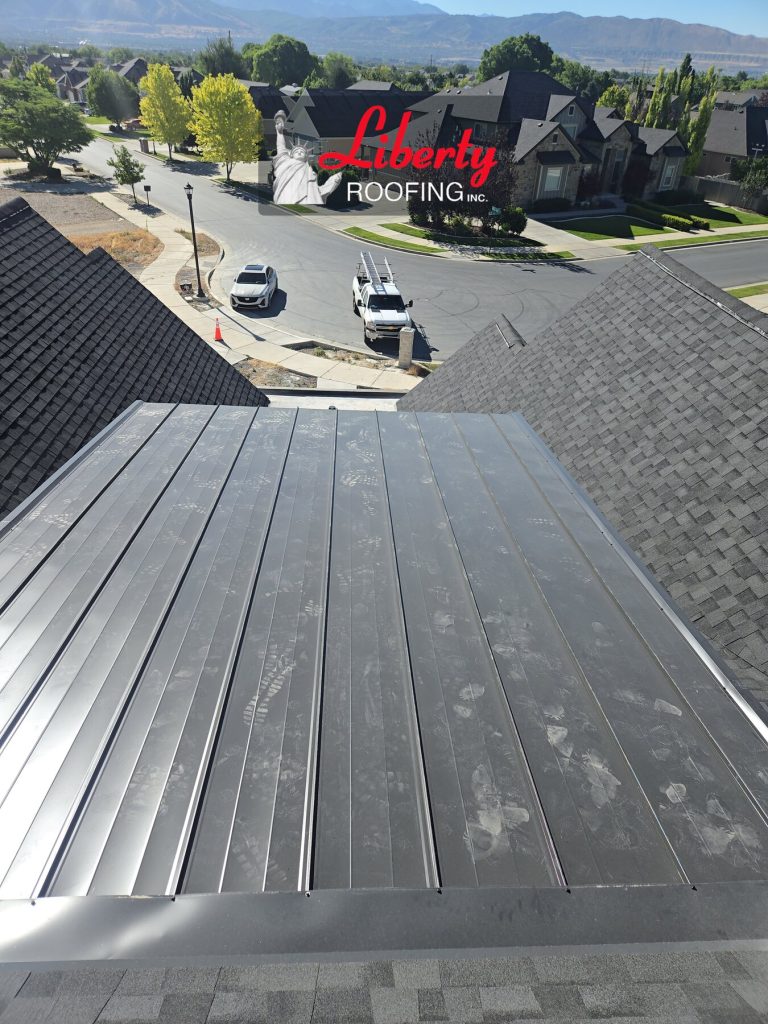 26 gauge standing seam metal roofing between shingle roof sections on an American Fork new construction home