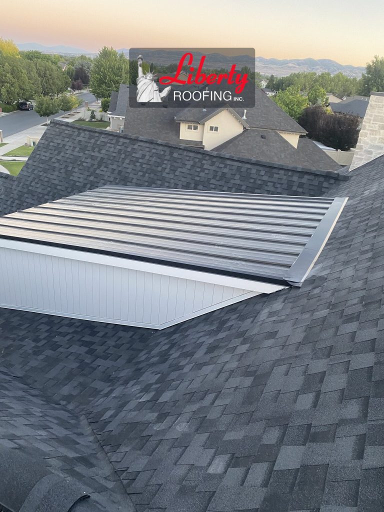 Standing seam metal roof over a white-sided dormer surrounded by gray shingles in American Fork, Utah