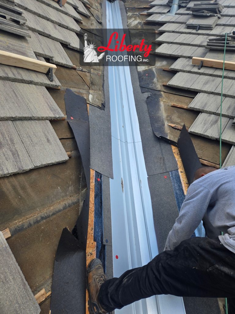 New metal valley flashing and underlayment during concrete tile roof repair in Provo, Utah